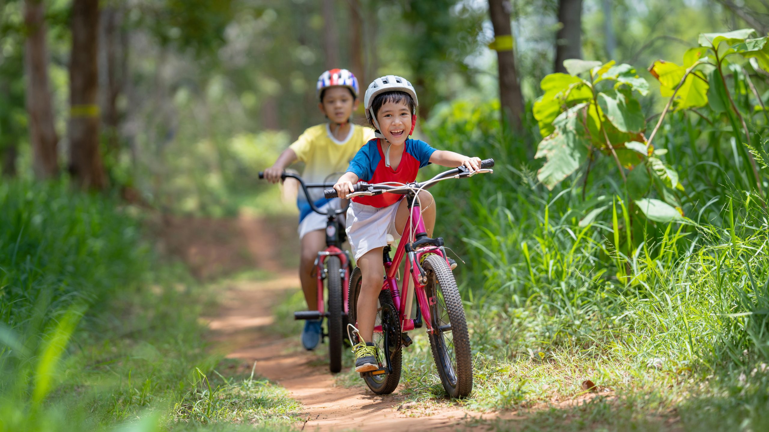 Asian children are happy mountain biking.